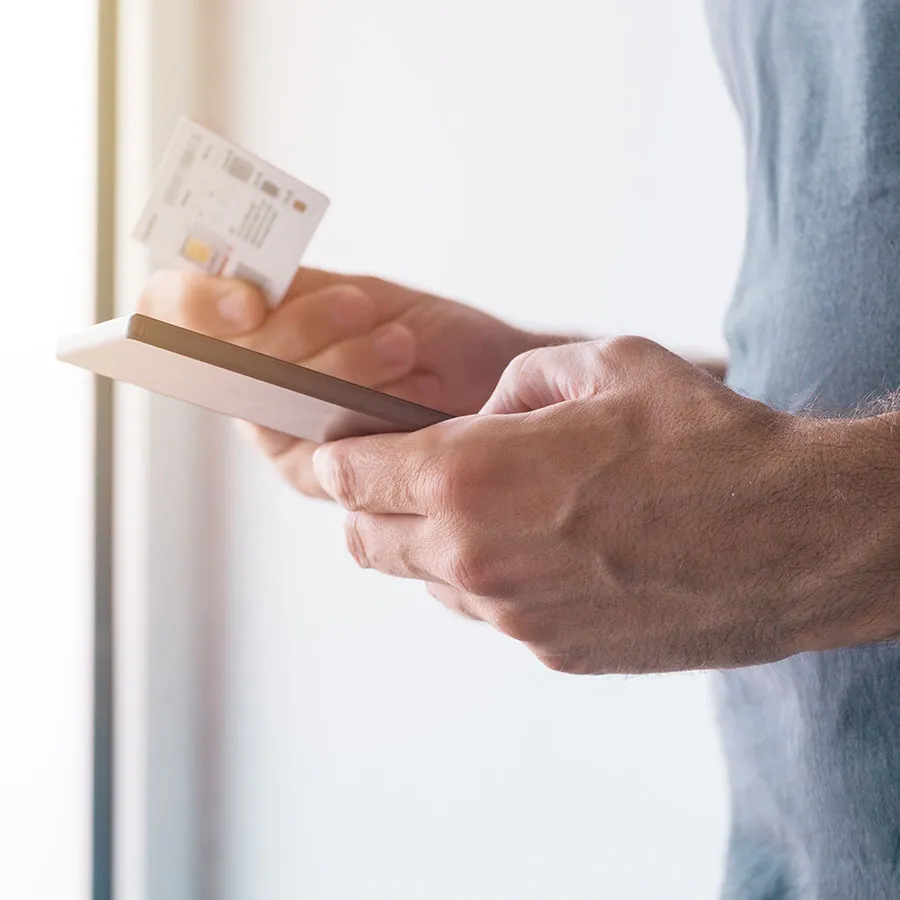 man holding sim card with his phone