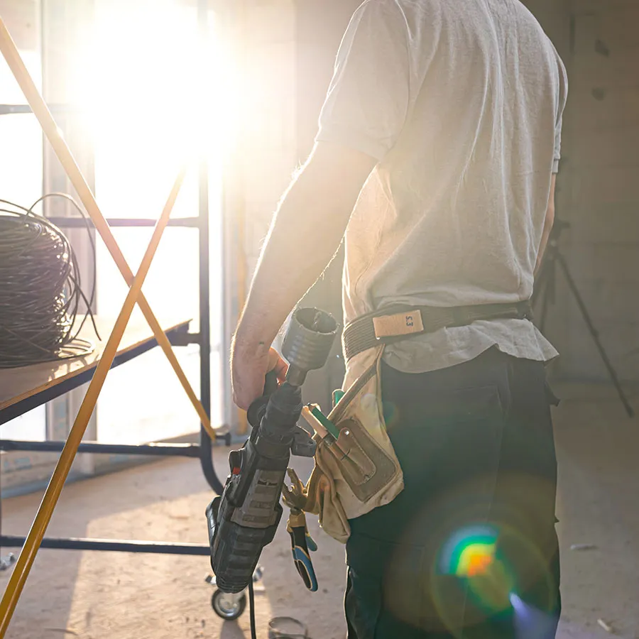 tradesman holding power tools